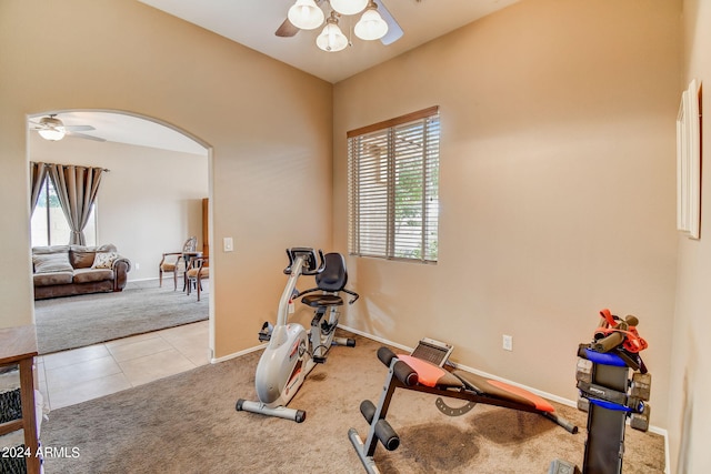 workout area featuring ceiling fan and light tile patterned floors