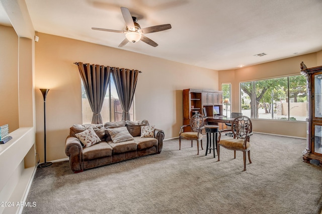 living room featuring carpet and ceiling fan