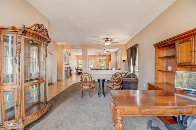 interior space with ceiling fan and light carpet