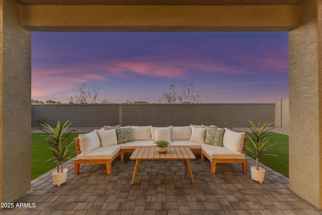 patio terrace at dusk featuring outdoor lounge area