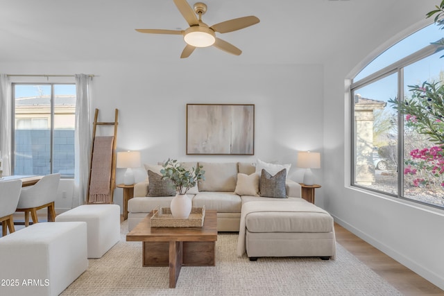 living room with light hardwood / wood-style floors and ceiling fan