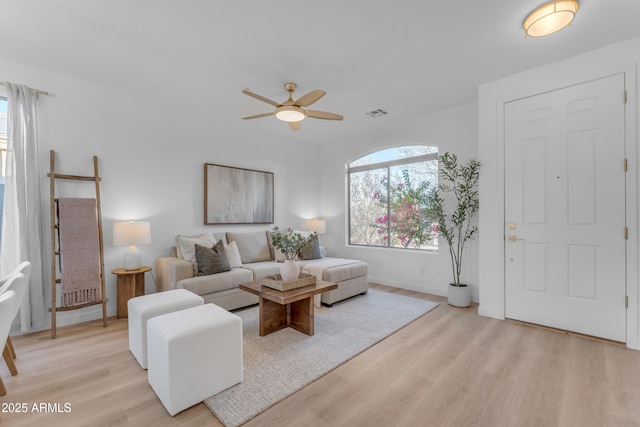 living room with ceiling fan and light wood-type flooring