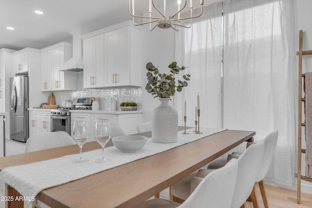 dining space with a chandelier and light wood-type flooring