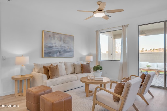 living room featuring ceiling fan and light wood-type flooring