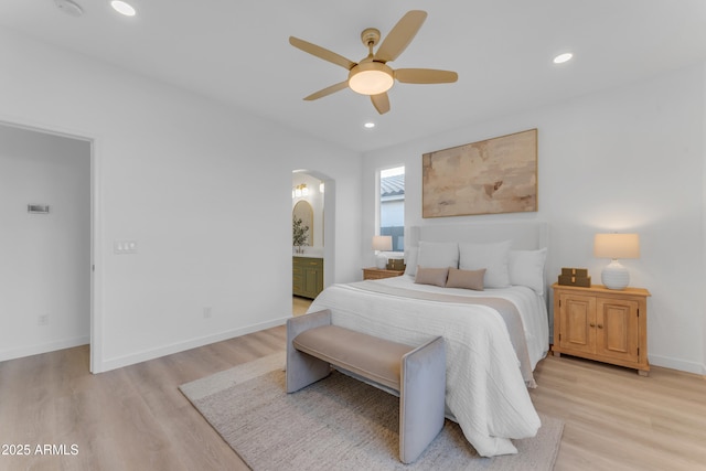 bedroom with light hardwood / wood-style flooring, ceiling fan, and ensuite bathroom