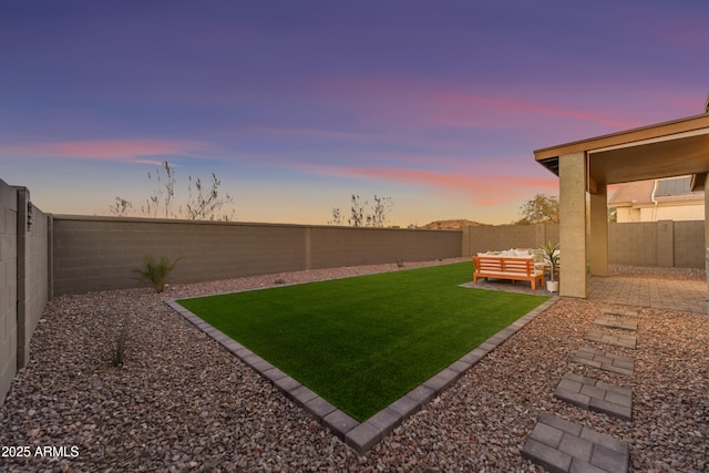 yard at dusk featuring an outdoor hangout area and a patio area