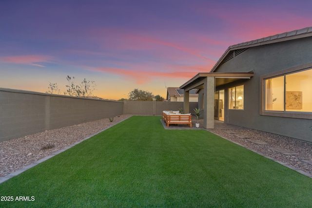 yard at dusk featuring outdoor lounge area