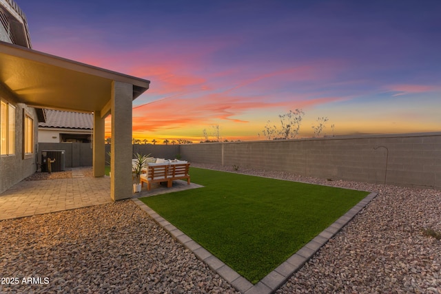 yard at dusk with an outdoor hangout area and a patio area