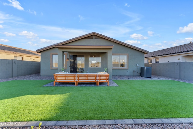 rear view of property featuring cooling unit, an outdoor hangout area, and a lawn