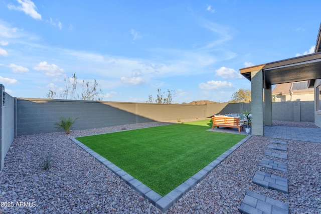 view of yard featuring an outdoor living space and a patio area