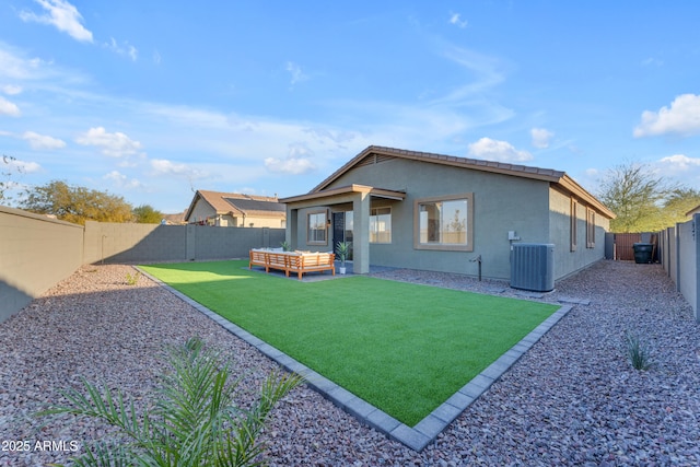 back of house featuring central AC unit, an outdoor hangout area, and a lawn