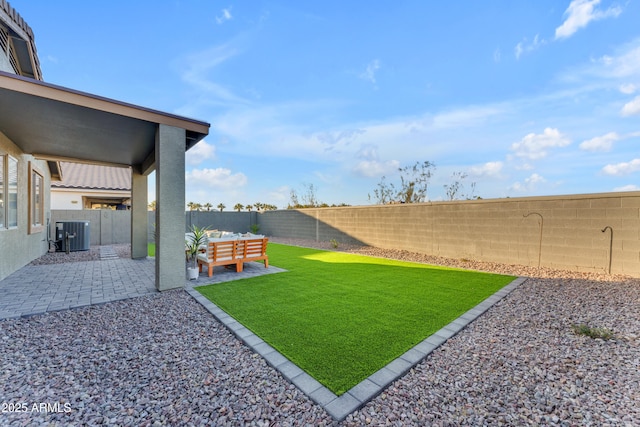 view of yard featuring a patio and central air condition unit