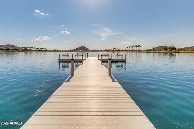 view of dock featuring a water and mountain view