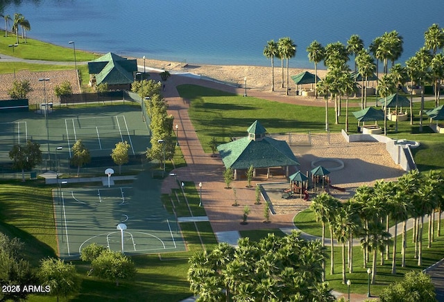 exterior space featuring a gazebo, a lawn, a playground, and a water view