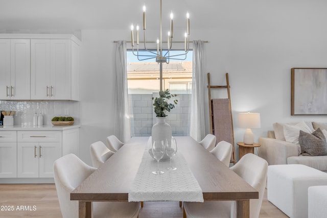 dining room with a notable chandelier and light hardwood / wood-style flooring