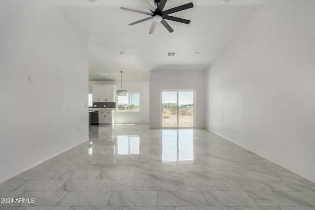 unfurnished living room with ceiling fan and light tile patterned flooring