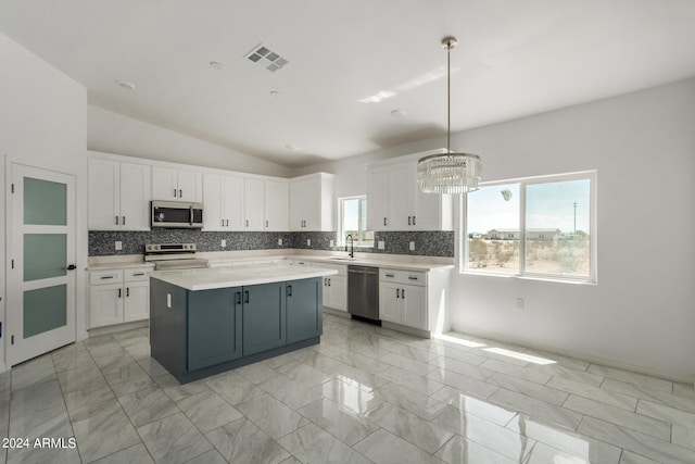 kitchen with dishwasher, a center island, stove, and decorative light fixtures