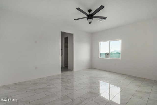 empty room with light tile patterned floors and ceiling fan