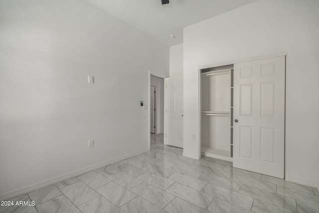 unfurnished bedroom featuring light tile patterned flooring and a closet