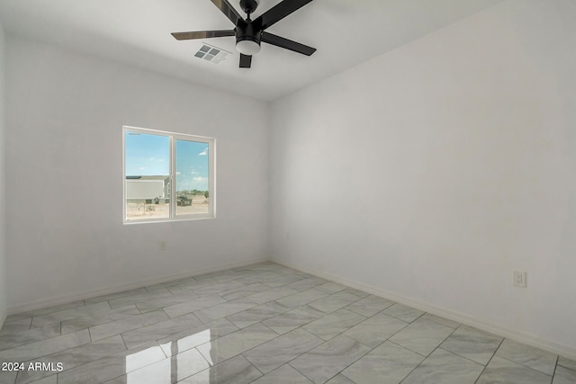 tiled spare room with ceiling fan