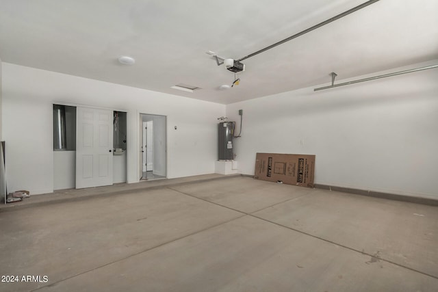 garage featuring electric water heater and a garage door opener