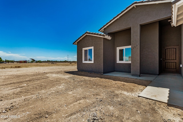 view of side of property featuring a patio