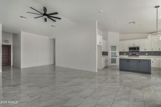 kitchen featuring light tile patterned floors, appliances with stainless steel finishes, a center island, and white cabinets