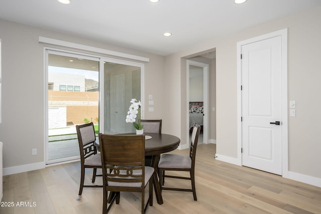 dining area featuring recessed lighting, baseboards, and light wood finished floors