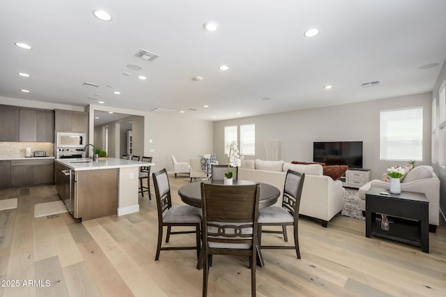dining area with visible vents, recessed lighting, and light wood-style floors