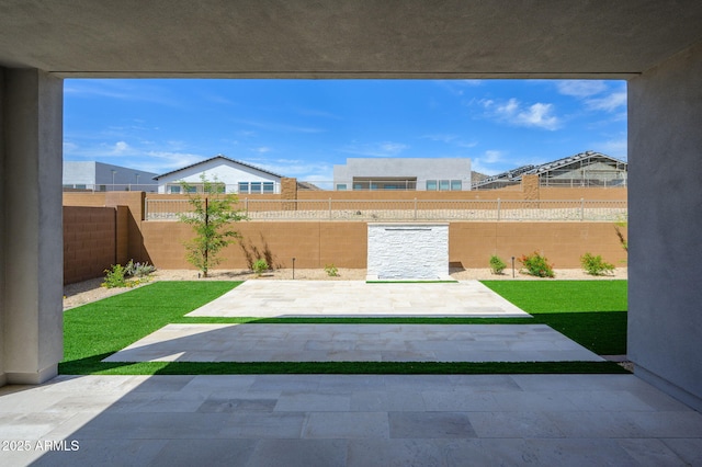 view of yard with a fenced backyard and a patio area