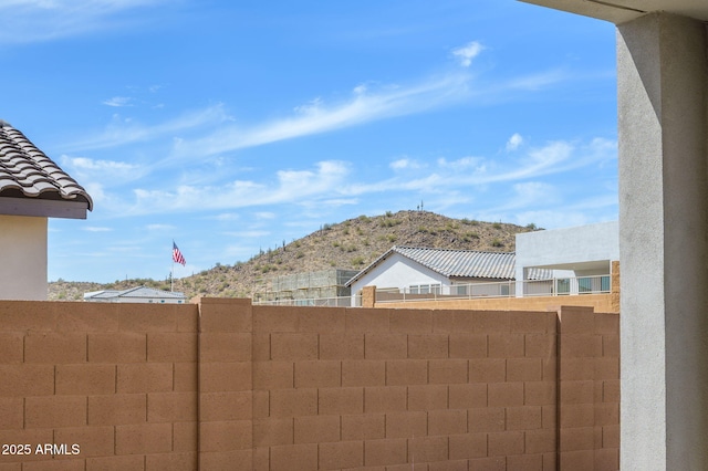 exterior space featuring a mountain view and fence