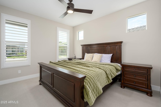 bedroom featuring a ceiling fan, baseboards, and light colored carpet