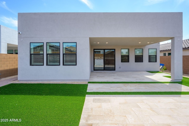 back of house with stucco siding, a patio area, and fence