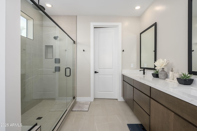 bathroom featuring double vanity, recessed lighting, tile patterned floors, a shower stall, and a sink