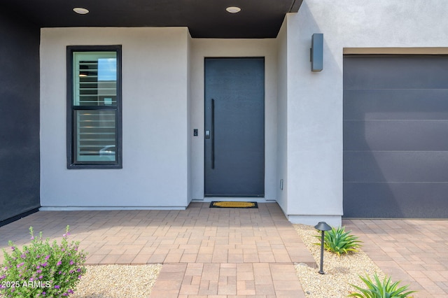 entrance to property with stucco siding