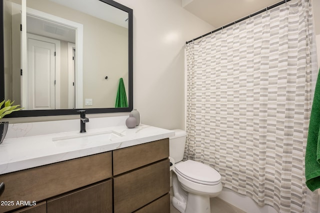 bathroom with vanity, curtained shower, and toilet