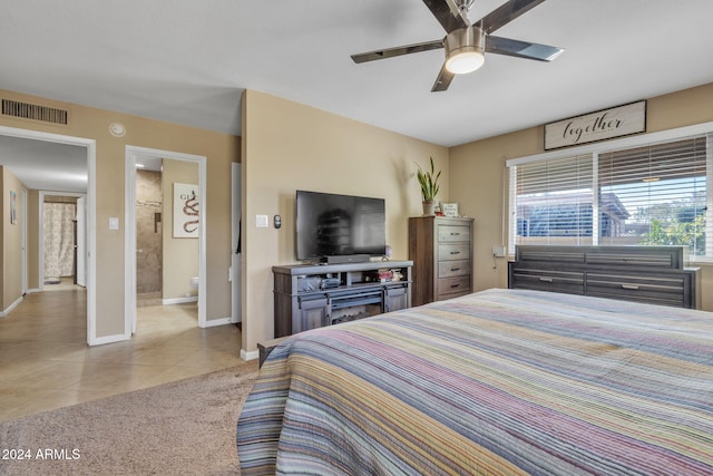 tiled bedroom featuring ceiling fan and ensuite bathroom