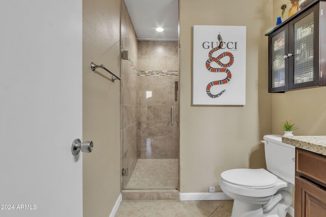 bathroom with toilet, a shower with door, vanity, and tile patterned flooring