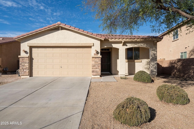 mediterranean / spanish home featuring a garage, a tile roof, driveway, stone siding, and stucco siding