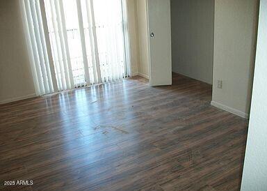 unfurnished room featuring dark hardwood / wood-style flooring