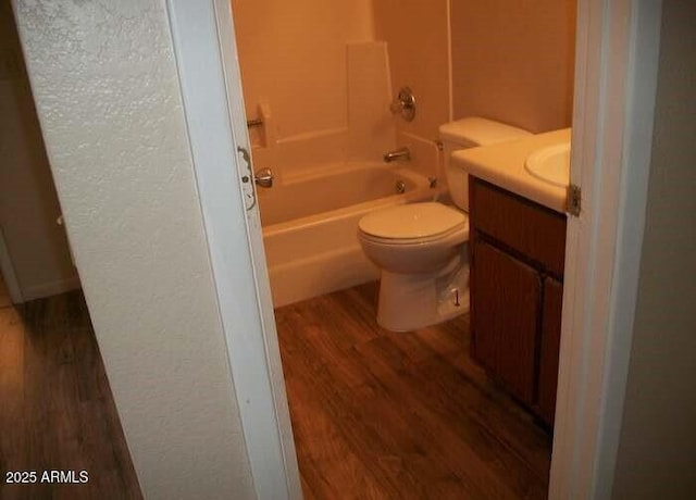 full bathroom featuring shower / bath combination, vanity, wood-type flooring, and toilet