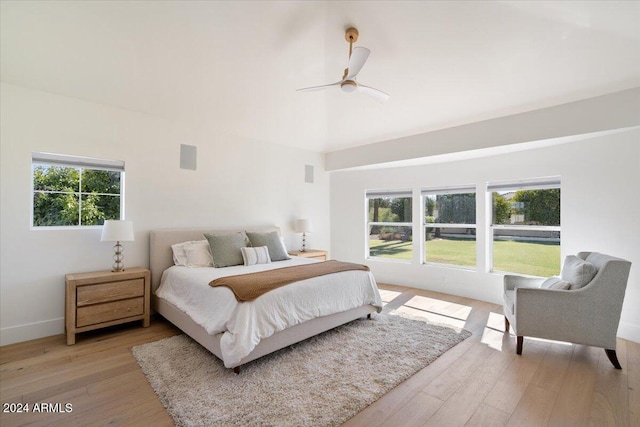 bedroom with light hardwood / wood-style flooring, multiple windows, and ceiling fan