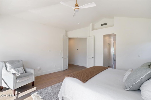 bedroom featuring hardwood / wood-style flooring, vaulted ceiling, and ceiling fan