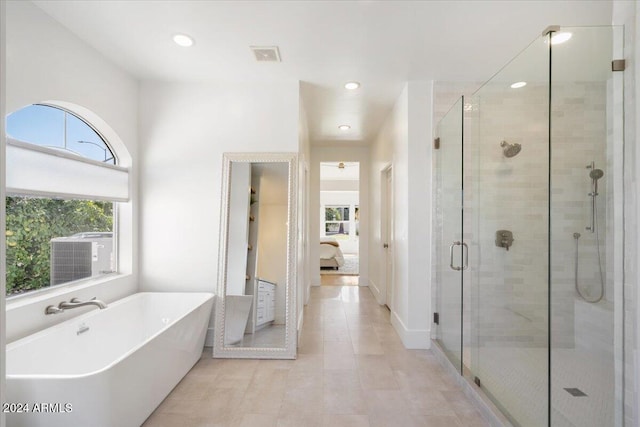 bathroom featuring separate shower and tub and tile patterned flooring