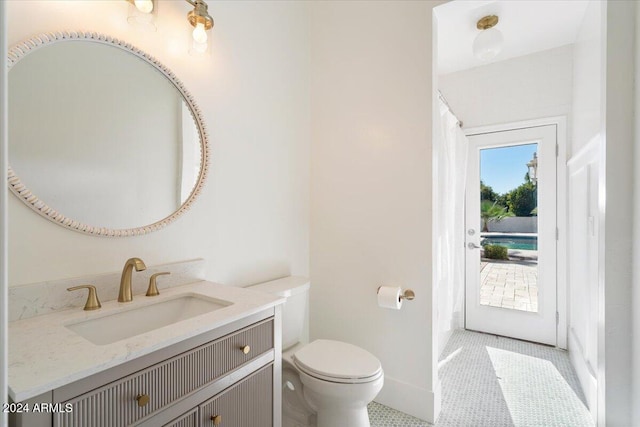 bathroom with vanity, toilet, and tile patterned floors