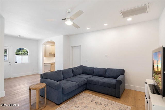 living room featuring light hardwood / wood-style floors and ceiling fan