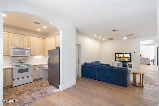 kitchen featuring light hardwood / wood-style floors, white appliances, and ceiling fan