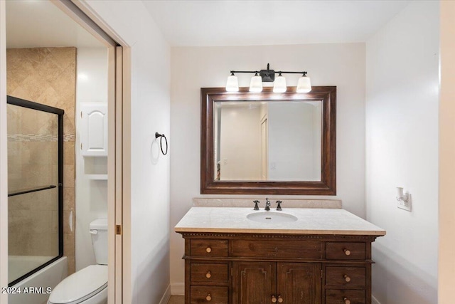 full bathroom with vanity, combined bath / shower with glass door, and toilet