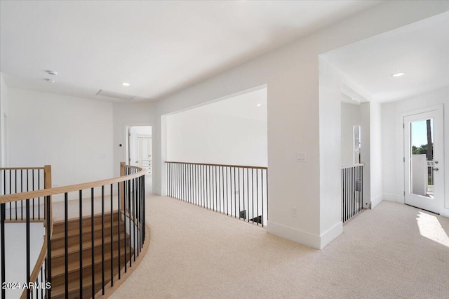 corridor with light colored carpet