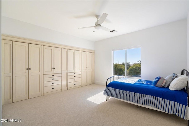 bedroom featuring light colored carpet and ceiling fan